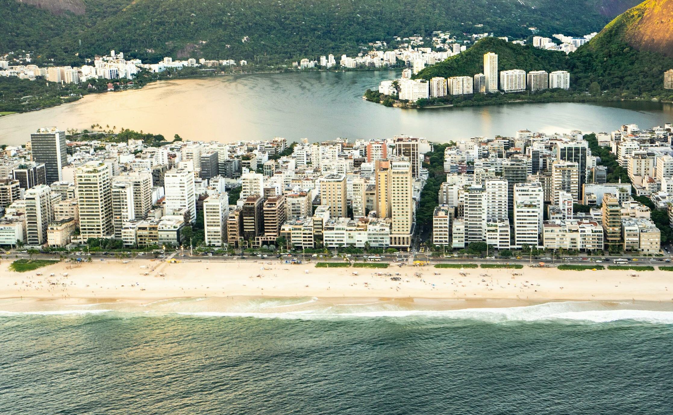 Stunning aerial view of Rio de Janeiro's vibrant beachfront with mountains and cityscape.